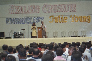 Julie preaching at healing campaign