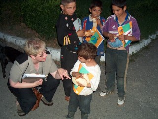 Julie shares food & Book of Hope with street kids