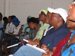 Workers take notes during the evangelism training